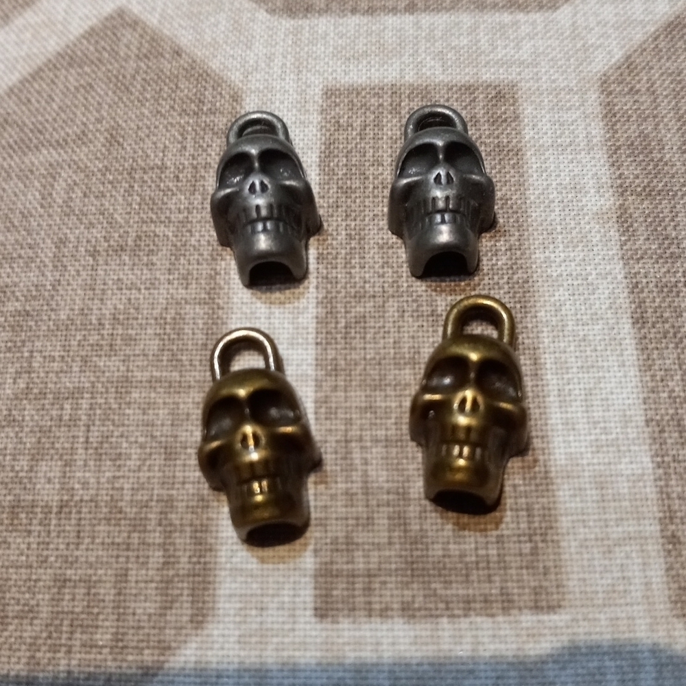 Lot of 4 silver/gold mini skull pendants